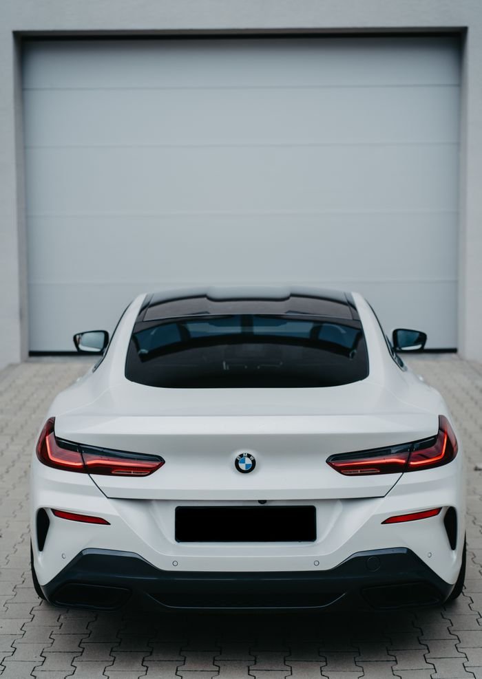 Sleek white BMW sports car showcased from the rear, perfect for showing luxury automotive design.