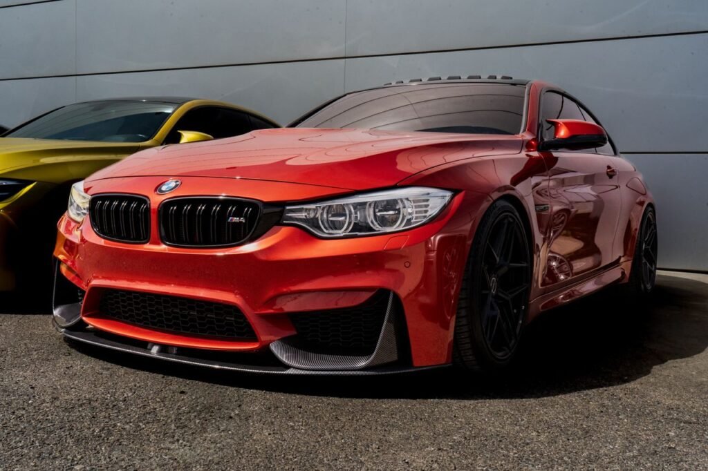 Vibrant red sports car parked outdoors, showcasing sleek design and modern style.